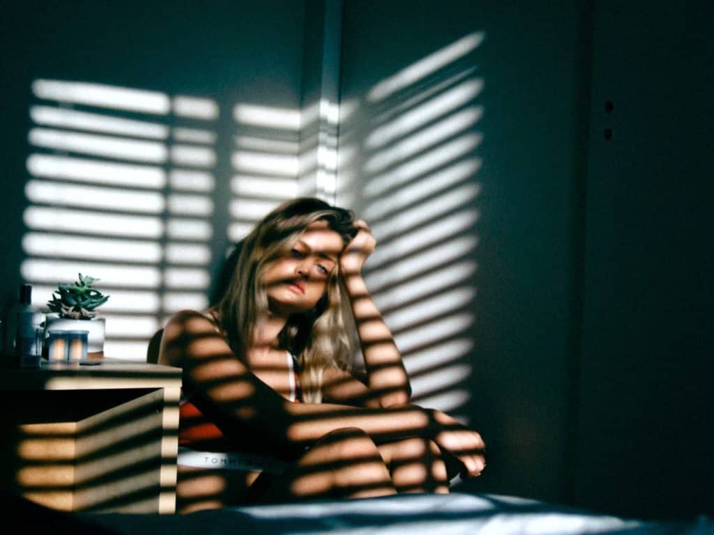 woman in corner of dark room